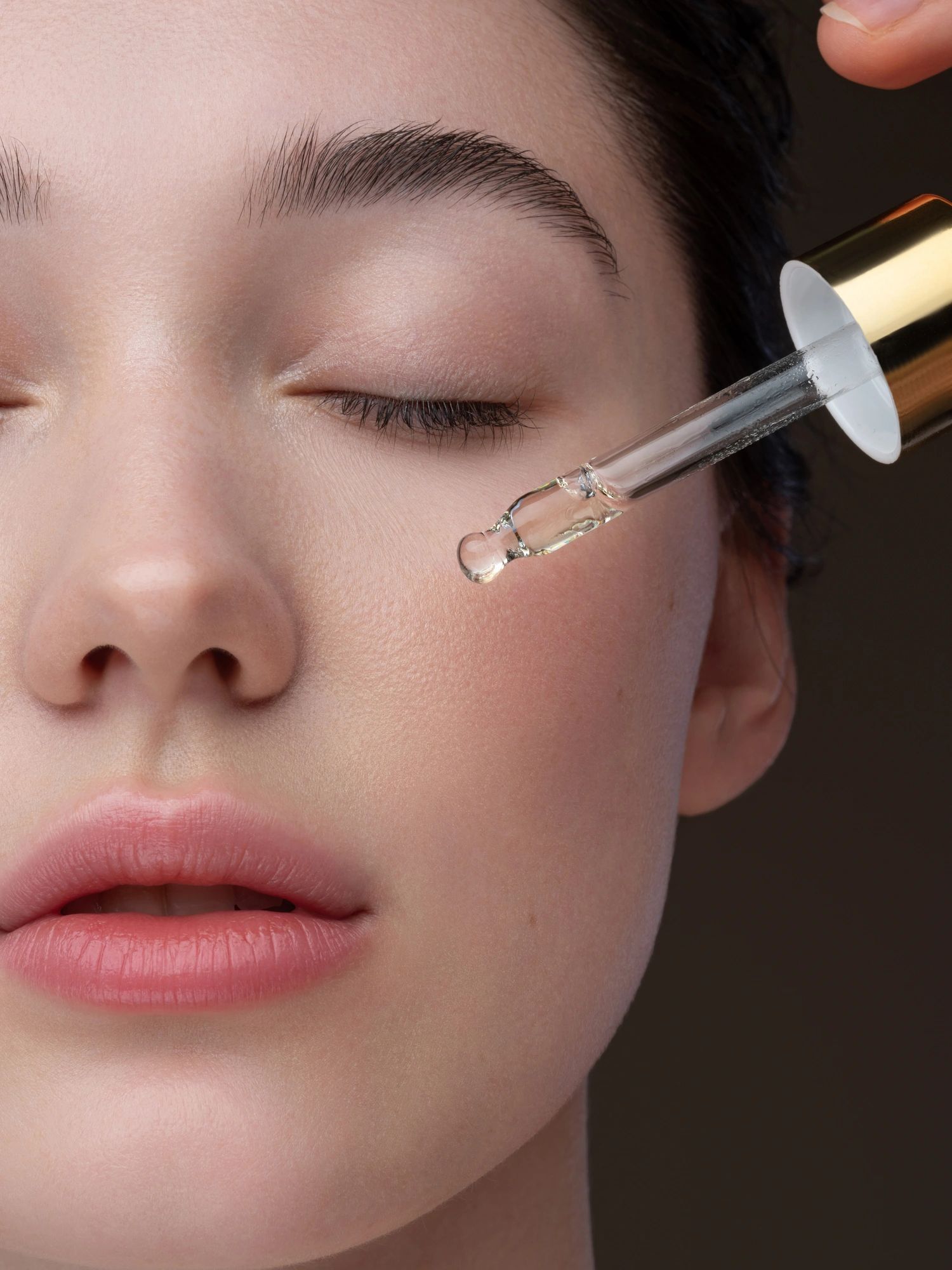 Close-up portrait of woman receiving anti-aging skincare treatment