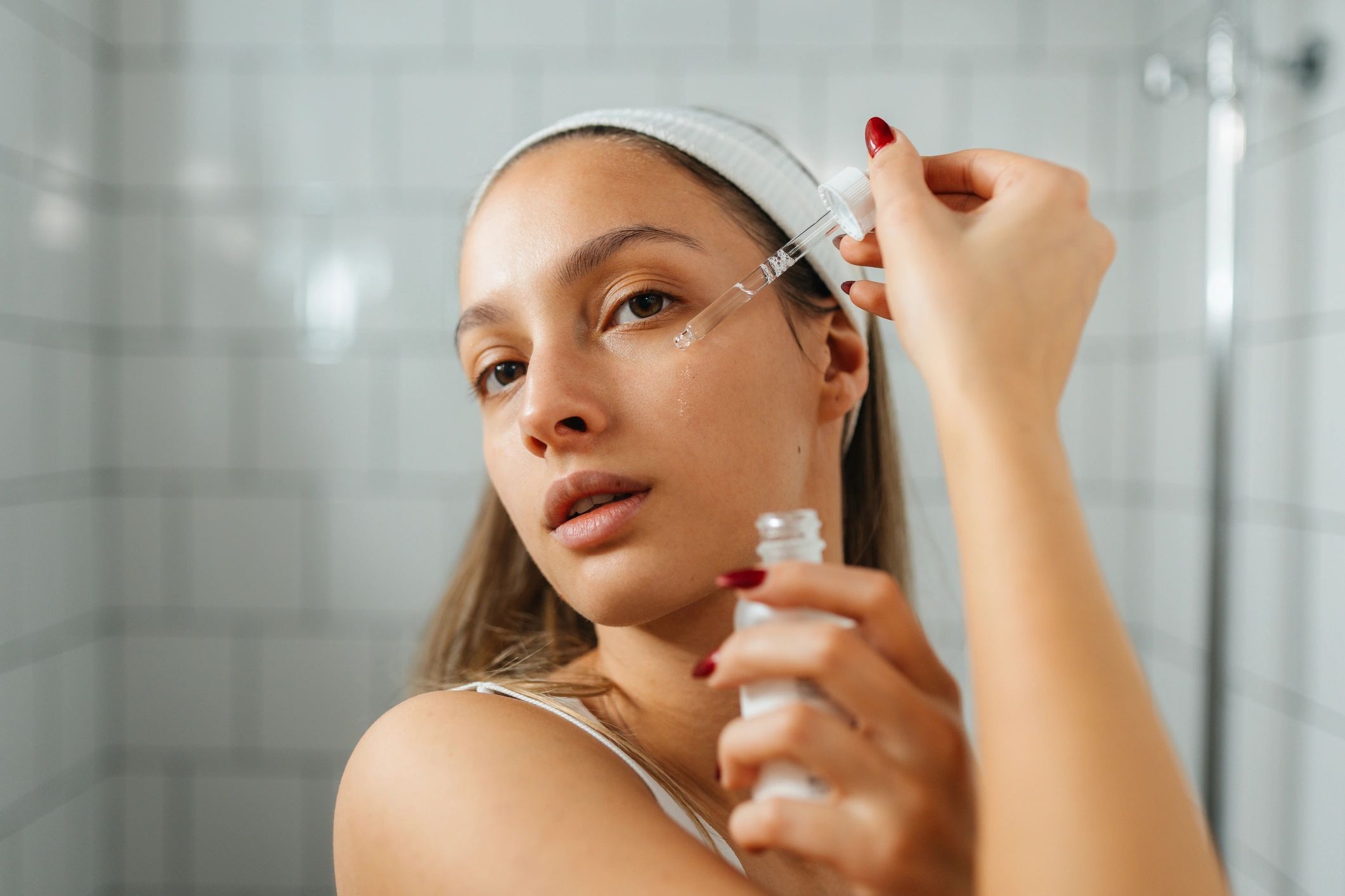 Woman applying facial serum during skincare routine